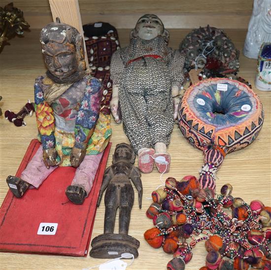 Two head dresses, an Indian carving, an Indian puppet, another Indian headdress, a wooden puppet and a book largest headdress length 48